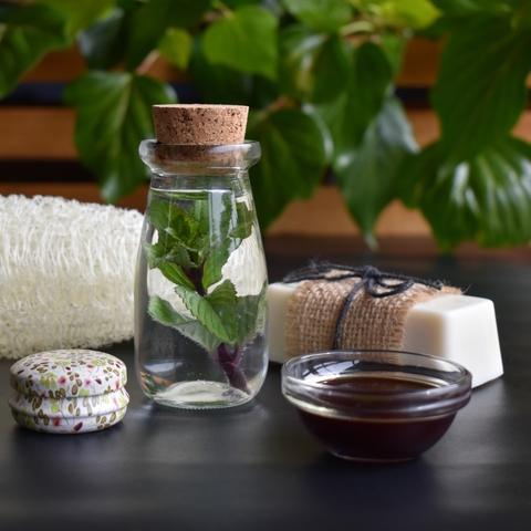 A natural loofah in the background with skincare ingredients